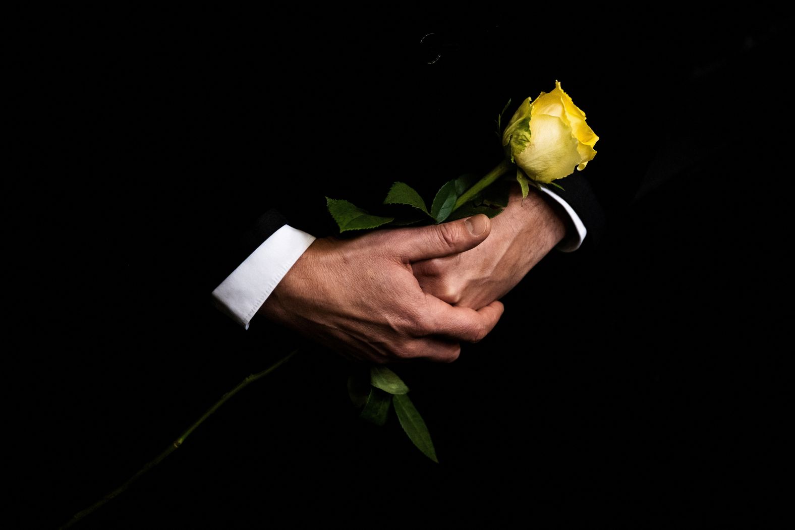 A man in Budapest, Hungary, holds a flower Thursday, January 9, during the funeral of Ágnes Keleti, a former gymnast who won five gold medals in gymnastics. She was 103.