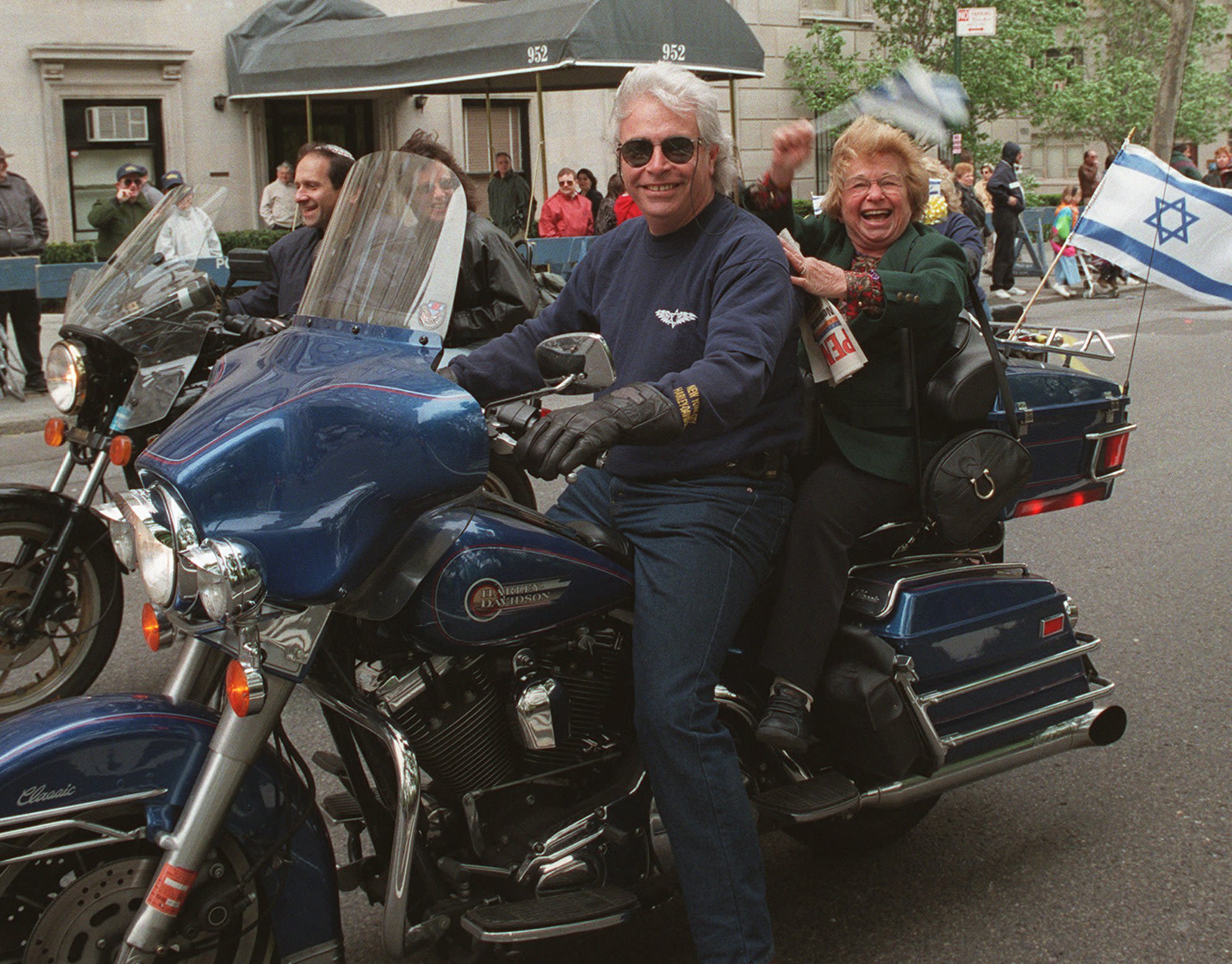 Westheimer rides on the back of a motorcycle during New York's Salute to Israel Parade in May 1996.