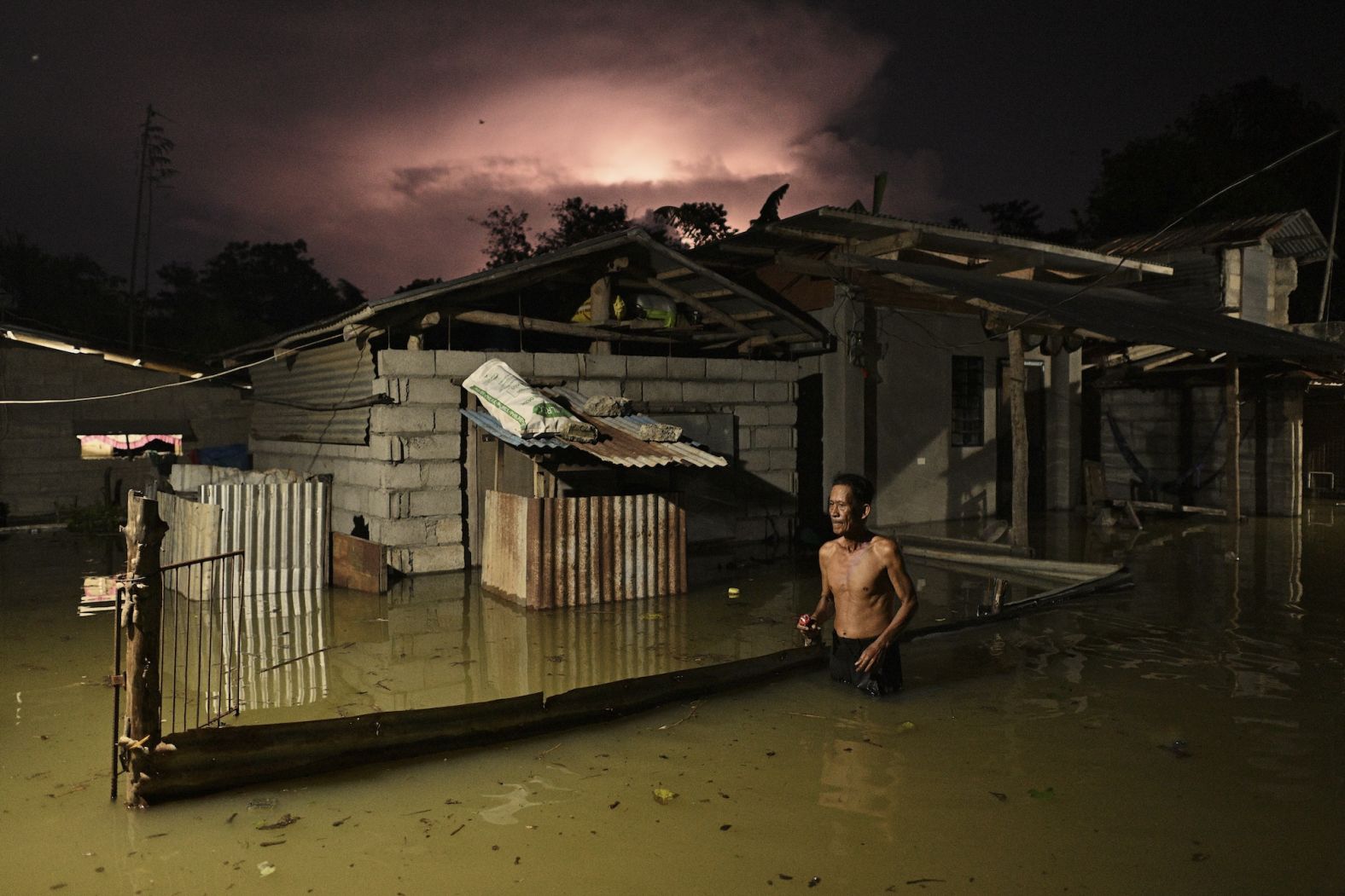 A resident of Ilagan, Philippines, wades through a flooded street caused by heavy rains from Typhoon Toraji on Tuesday, November 12. <a href="index.php?page=&url=https%3A%2F%2Fwww.cnn.com%2F2024%2F11%2F12%2Fclimate%2Fphilippines-storms-west-pacific-intl-hnk%2Findex.html">Four separate storm systems</a> are churning their way through the West Pacific simultaneously, a rare occurrence that threatens to bring more misery to the storm-weary Philippines.