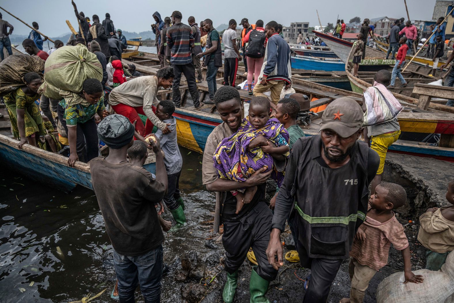 People fleeing rebel advances in the Democratic Republic of Congo arrive by boat in the Congolese city of Goma on Wednesday, January 22.