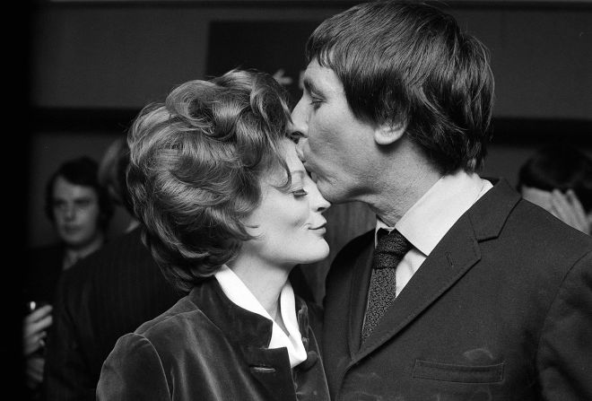 Stephens kisses Smith at a party to celebrate her Academy Award win for best actress in 1970. The couple divorced in 1975.