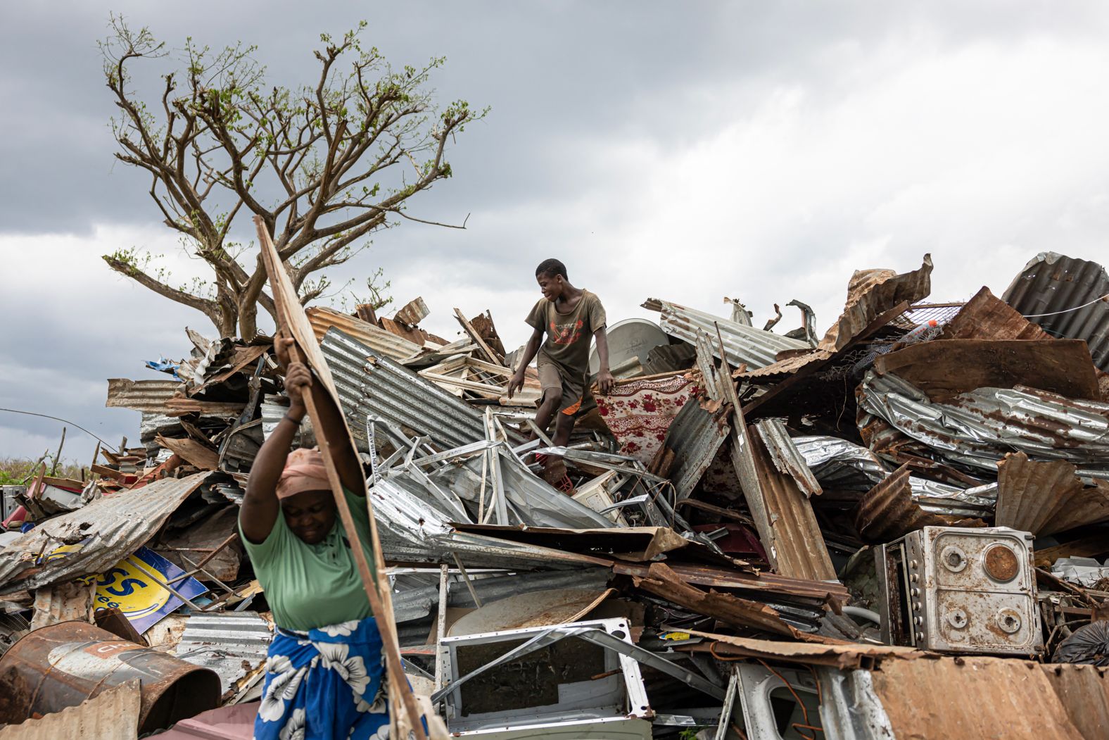 People collect metal sheets at a landfill in Tsountsou, on the French island of Mayotte, on Thursday, December 26. The Indian Ocean archipelago <a href="index.php?page=&url=https%3A%2F%2Fwww.cnn.com%2F2024%2F12%2F19%2Fworld%2Femmanuel-macron-france-mayotte-cyclone-intl-hnk%2Findex.html">was devastated by Cyclone Chido</a>.