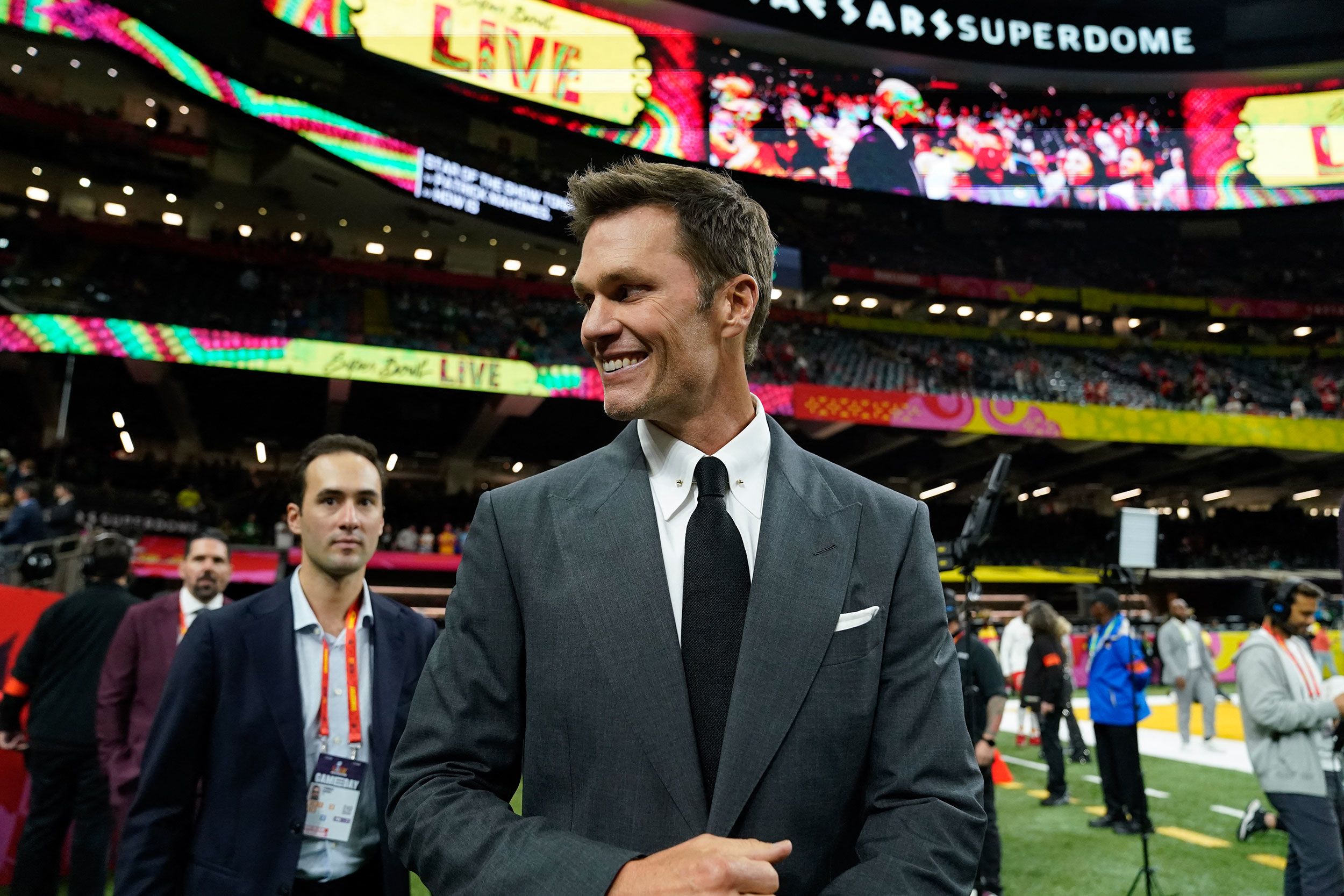 Fox analyst Tom Brady, who has won more Super Bowls than any player in NFL history, walks the sidelines before the game. This is Brady's first Super Bowl as a commentator.