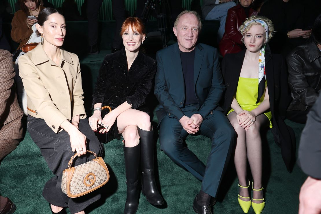 Gucci may be without a creative director but it still attracted a starry front row; from left: Danielle Pizzorni, Jessica Chastain, François-Henri Pinault and Julia Garner.