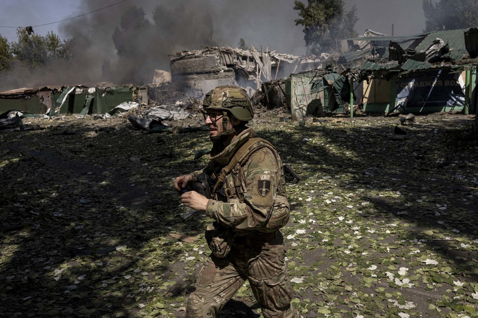 A Ukrainian soldier walks past the scene of a Russian strike minutes earlier near Pokrovsk in the Donetsk region of Ukraine on Sunday, August 17.