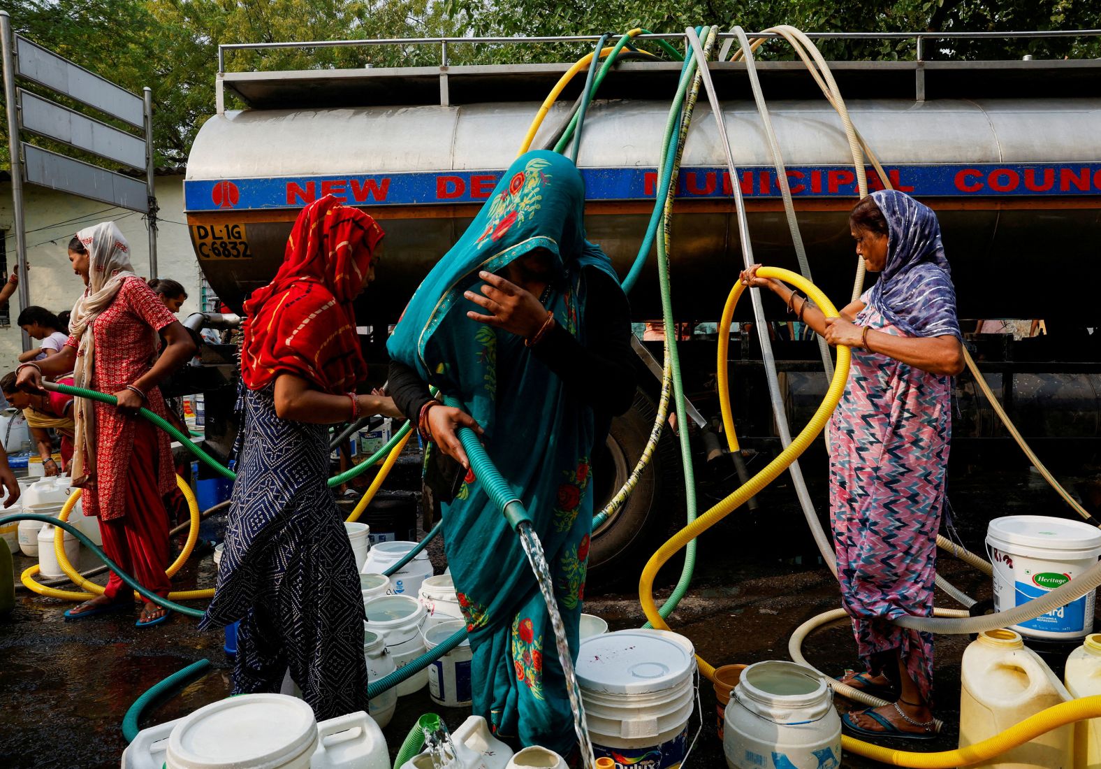 People visit a water tanker to fill their containers with drinking water during a hot day in New Delhi on Monday, June 24. <a href="index.php?page=&url=https%3A%2F%2Fwww.cnn.com%2F2024%2F06%2F21%2Findia%2Findia-delhi-nighttime-heatwave-climate-intl-hnk%2Findex.html">Northern India has endured a scorching summer</a>, with one part of Delhi reaching 49.9 degrees Celsius (121.8 degrees Fahrenheit) in late May — the capital’s highest temperature on record.