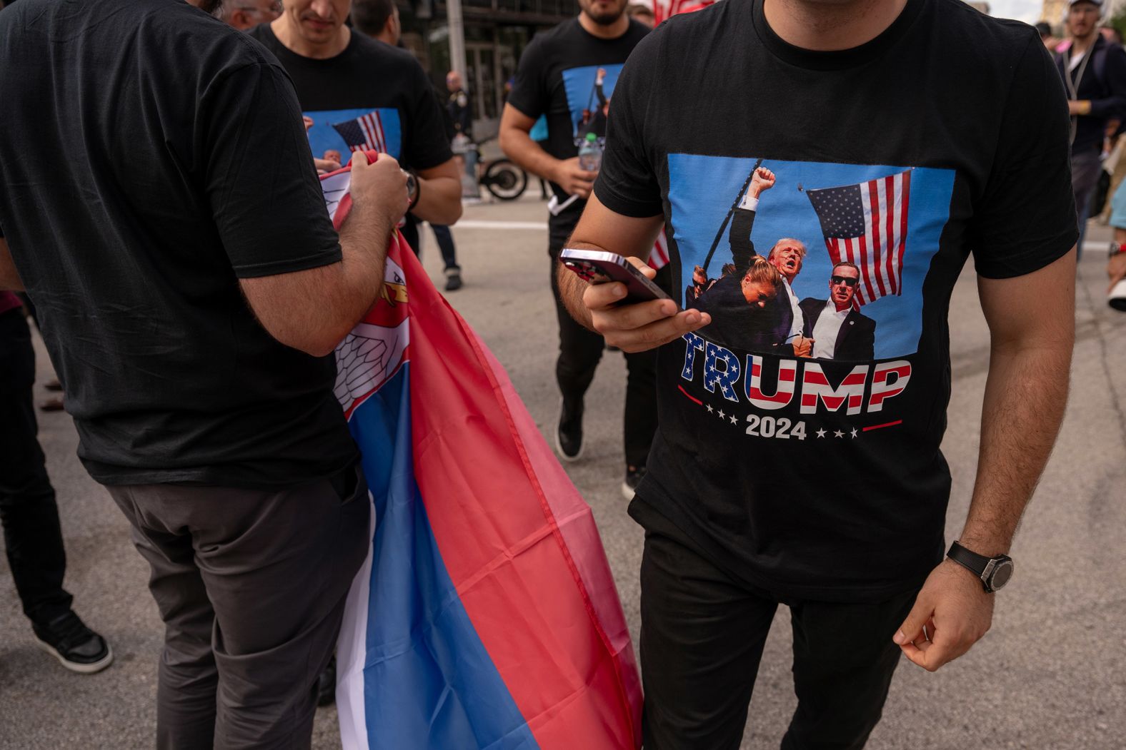 Trump supporters wear shirts that show Trump raising his fist after he survived his assassination attempt.