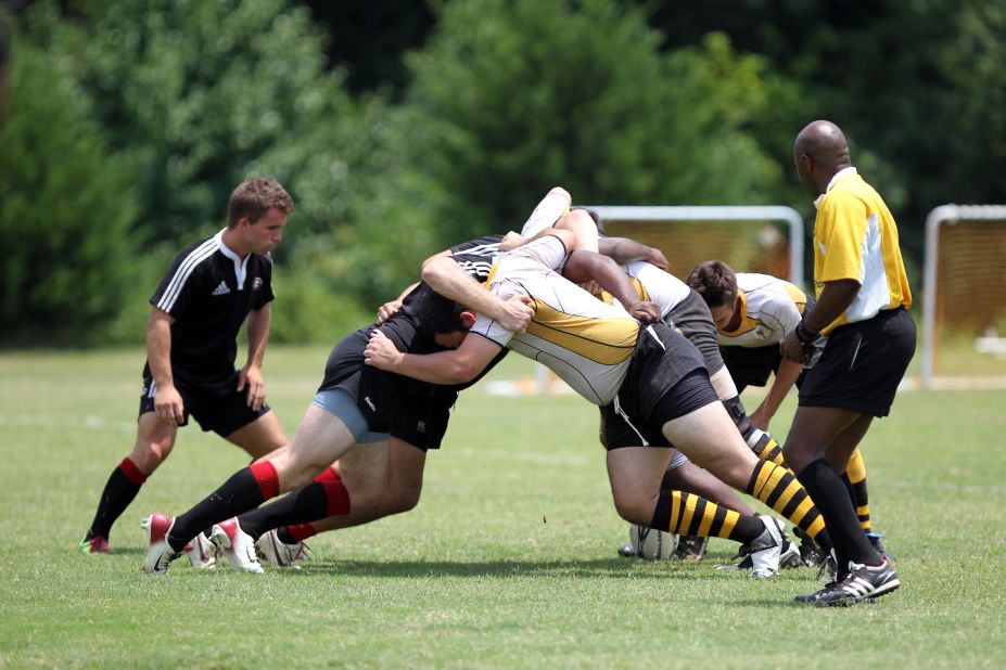 Rugby teams from across the southeastern U.S. met up for the Hotlanta Sevens Rugby Tournament in Cumming, Georgia, on Saturday, July 9, 2011. The University of Georgia (black jerseys) and Georgia Institute of Technology (yellow jerseys) rugby teams collide at the beginning of their game.