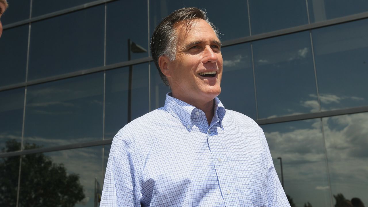 Mitt Romney arrives for a business roundtable to discuss the economy during a campaign stop in Pella, Iowa.