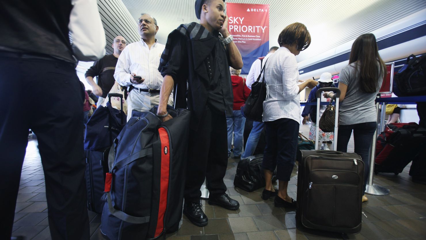 Travelers wait to board their flights at New York's LaGuardia Airport .