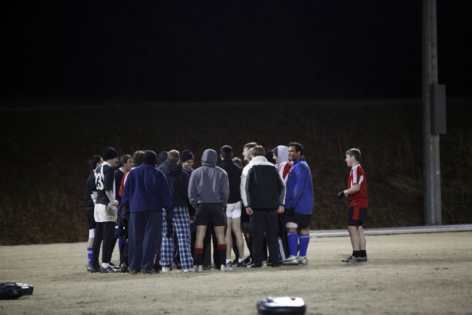 The team huddles after a cold night during winter practice.