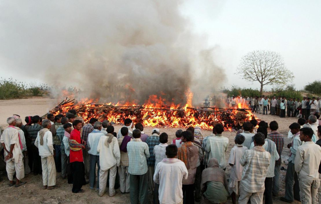 Indians pay last respects at a mass cremation of 15 school girls at the banks of the river Orsang in Bamroli on April 16, 2008.