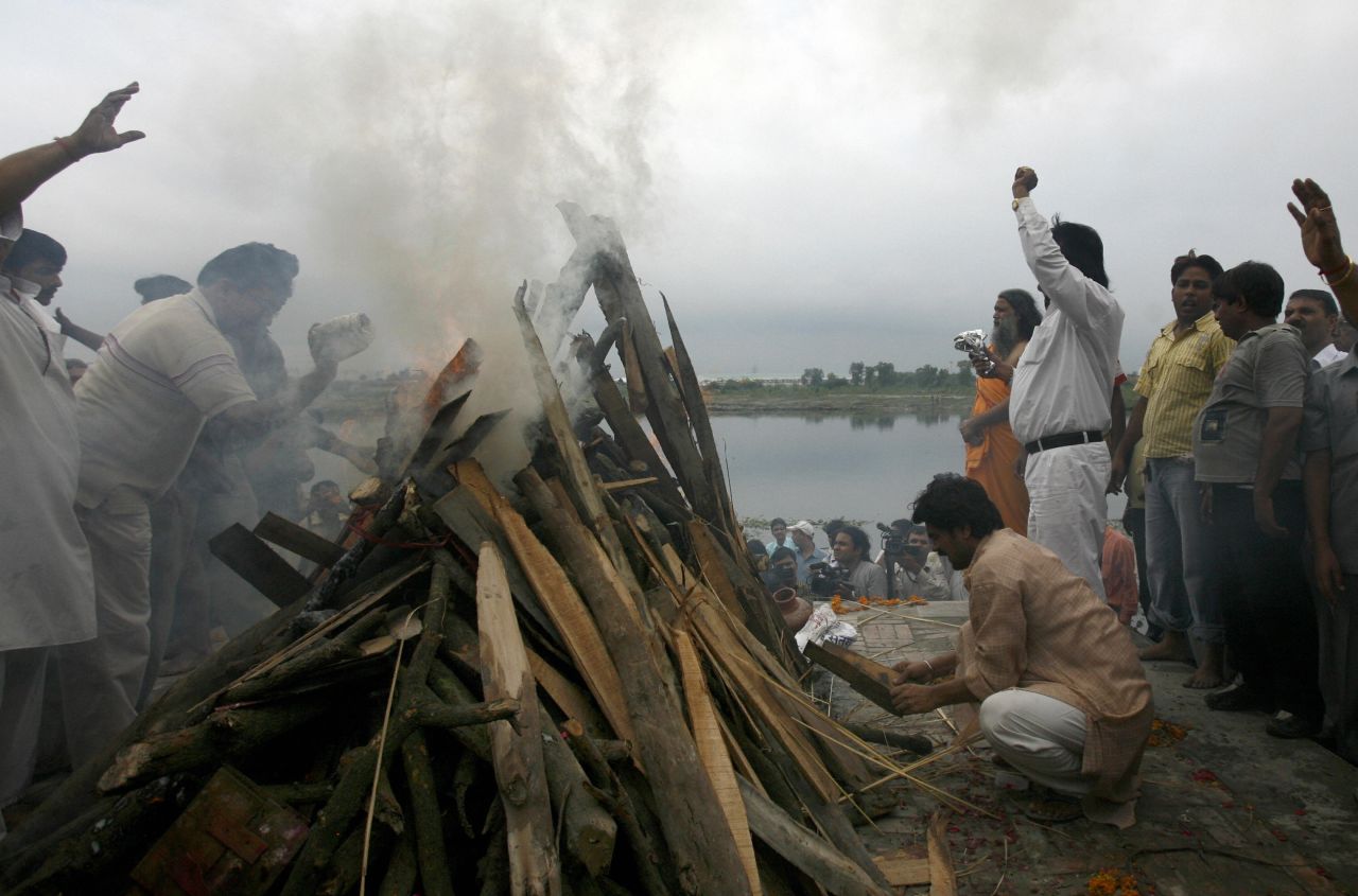 Friends and relatives of slain Indian police inspector Mohan Chand Sharma, who was killed during the 2008 Mumbai terror attacks, light a funeral pyre at a cremation ground in New Delhi.