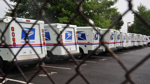 U.S. Postal Service mail delivery trucks sit idle at a Manassas post office in Virginia. 