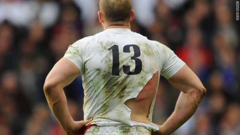 A red rose to a bull: England's Mike Tindall bears the scars and a torn shirt after finding himself on the end of a few boots while at the bottom of a ruck.
