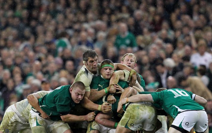 England lock Simon Shaw, with something attached to the right side of his head that vaguely resembles an ear, almost single-handedly tries to stop an Irish maul.  