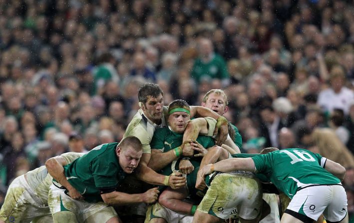 England lock Simon Shaw, with something attached to the right side of his head that vaguely resembles an ear, almost single-handedly tries to stop an Irish maul.