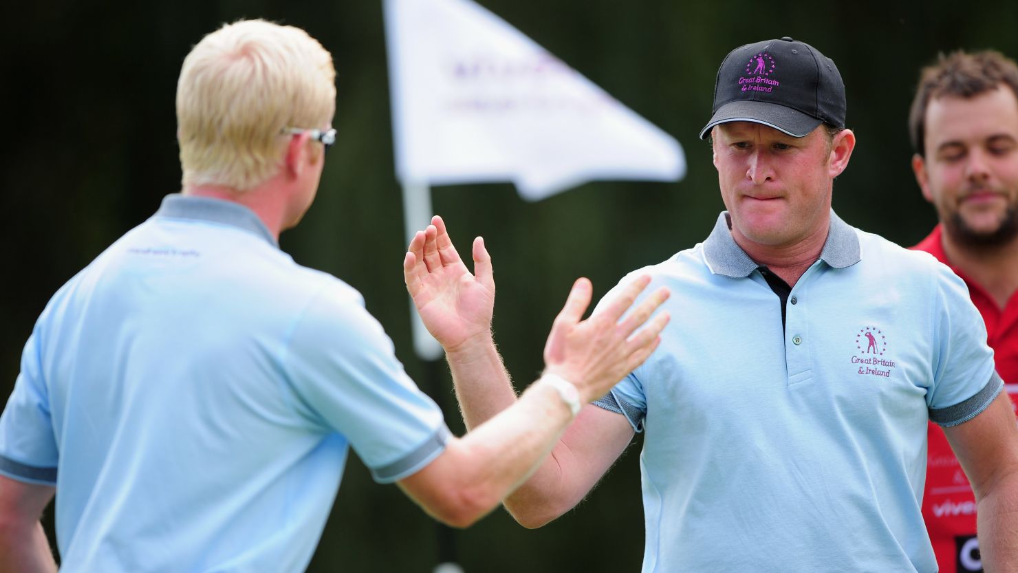 Jamie Donaldson, right, and Simon Dyson of the Great Britain & Ireland team celebrate during their victory on Thursday.