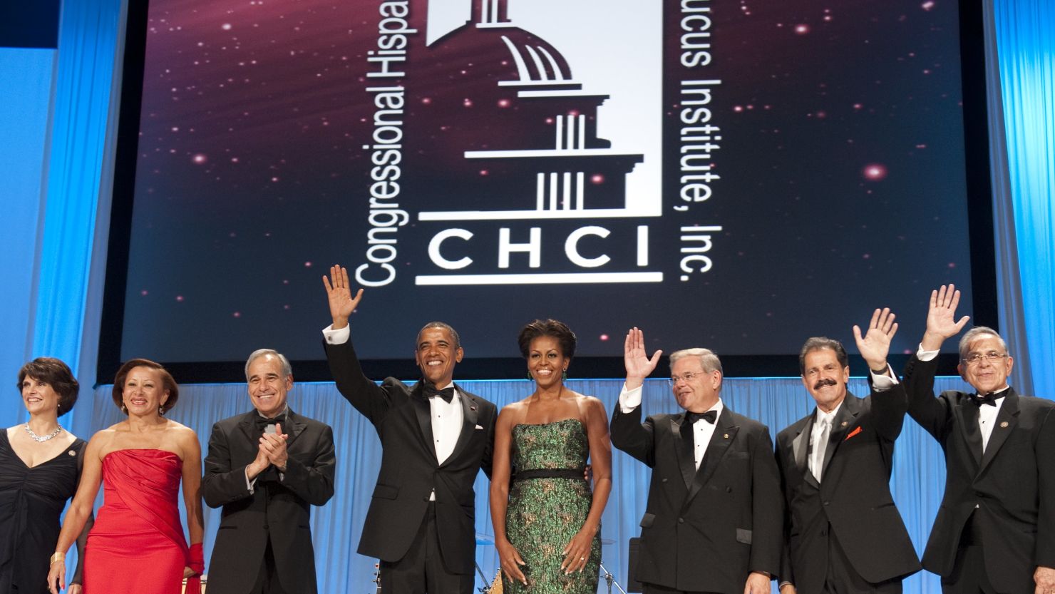President Barack Obama and First Lady Michelle Obama wave alongside Hispanic members of Congress as they attend the Congressional Hispanic Caucus Institute's gala Wednesday..