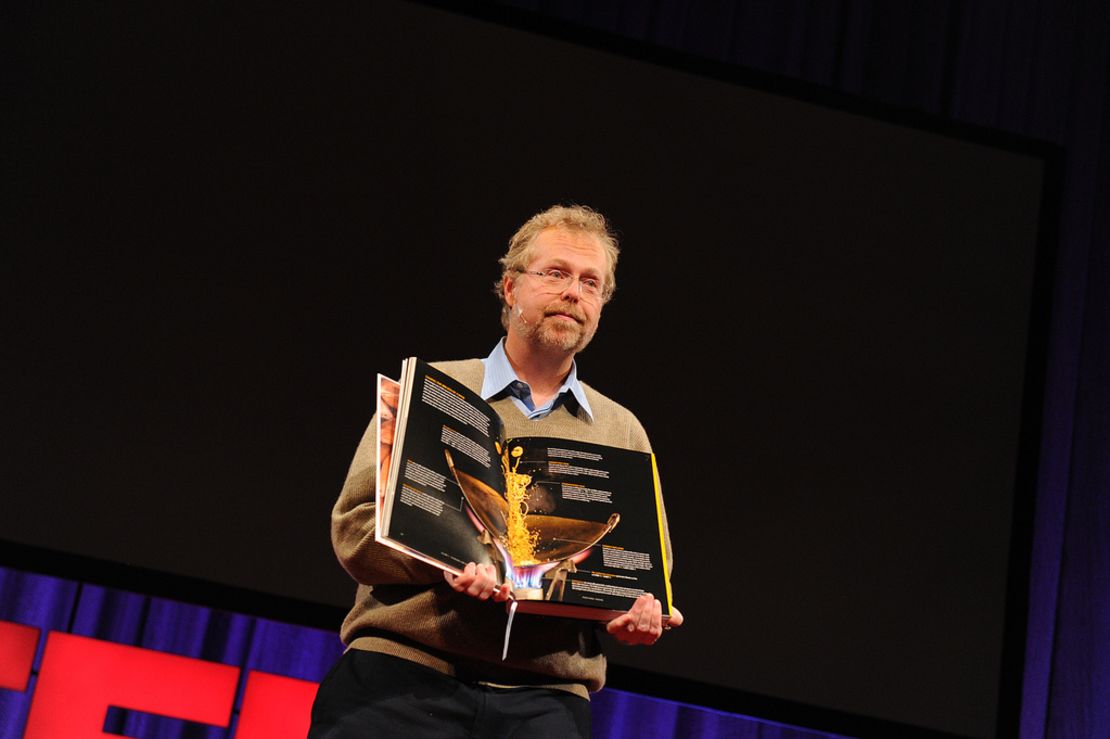 Nathan Myhrvold holds up his $625, 2,400-page book on the art and science of cooking, at TED2011 conference.