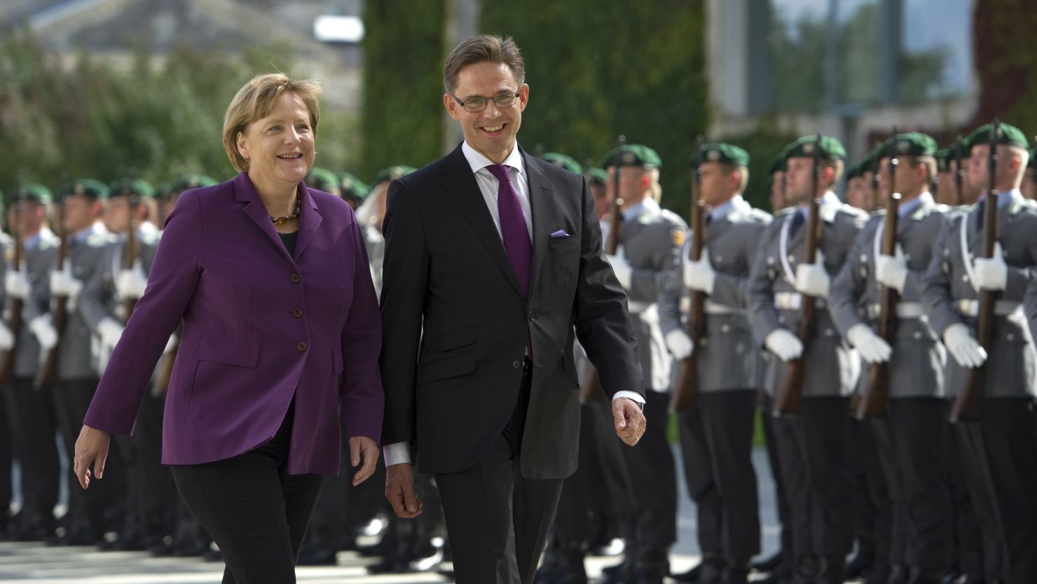 German Chancellor Angela Merkel (L) and Finland's Prime Minister Jyrki Katainen inspects the guard of honour before their meeting at the Chancellery in Berlin on September 13 , 2011.