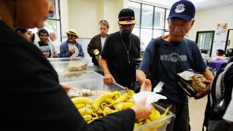 People pick up lunch in the soup kitchen of St. Francis Center on September 13 in Los Angeles, California.