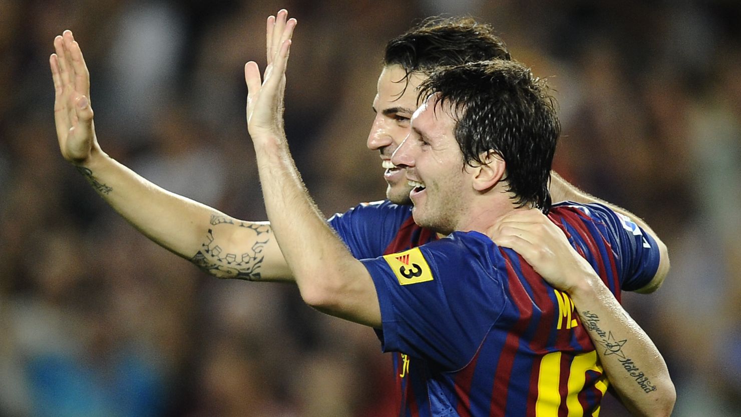 Lionel Messi and Cesc Fabregas celebrate a goal during the 8-0 rout of Osasuna 