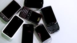 Blackberrys, iPhones and Android phones sit on white background. 