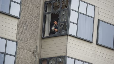 A worker removes glass from a window of an Amsterdam courthouse following the explosion in the early hours of the morning.