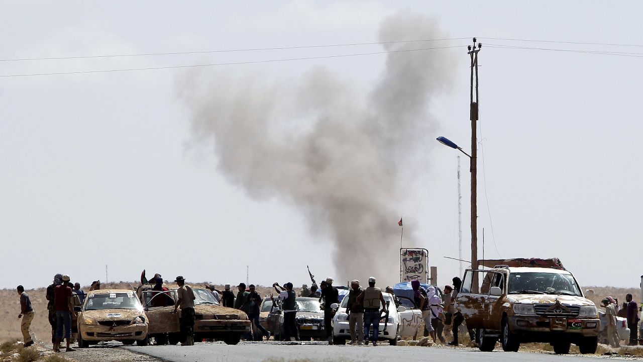 Gadhafi loyalists attack Libyan National Transitional Council fighters at an outpost near Bani Walid on Wednesday.