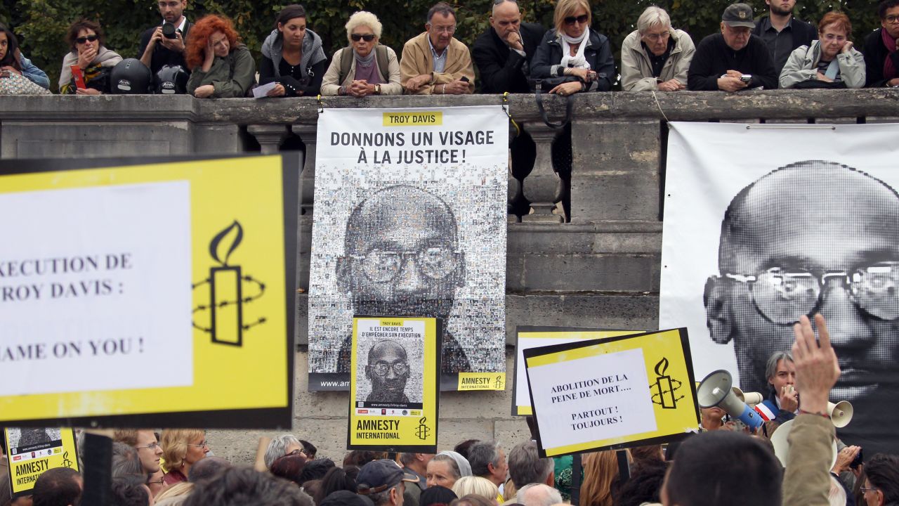 People hold placards on Wednesday during a demonstration in Paris against the execution of Troy Davis.