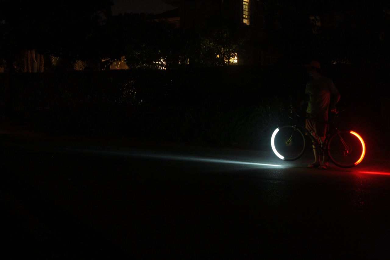 LED lights attached to wheel rims create a stunning glow of red and white light when the tires are in motion.