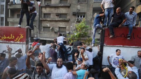Egyptian demonstrators in 2011 climb on a wall outside the Israeli embassy in Cairo.