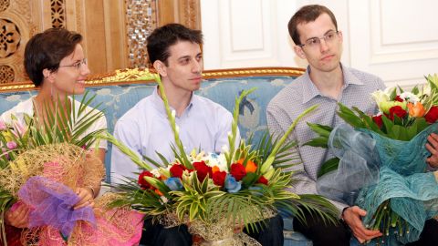 Hikers Josh Fattal, center, Shane Bauer and his fiancée Sarah Shourd sit in Muscat International airport before flying home to the United States in 2011.