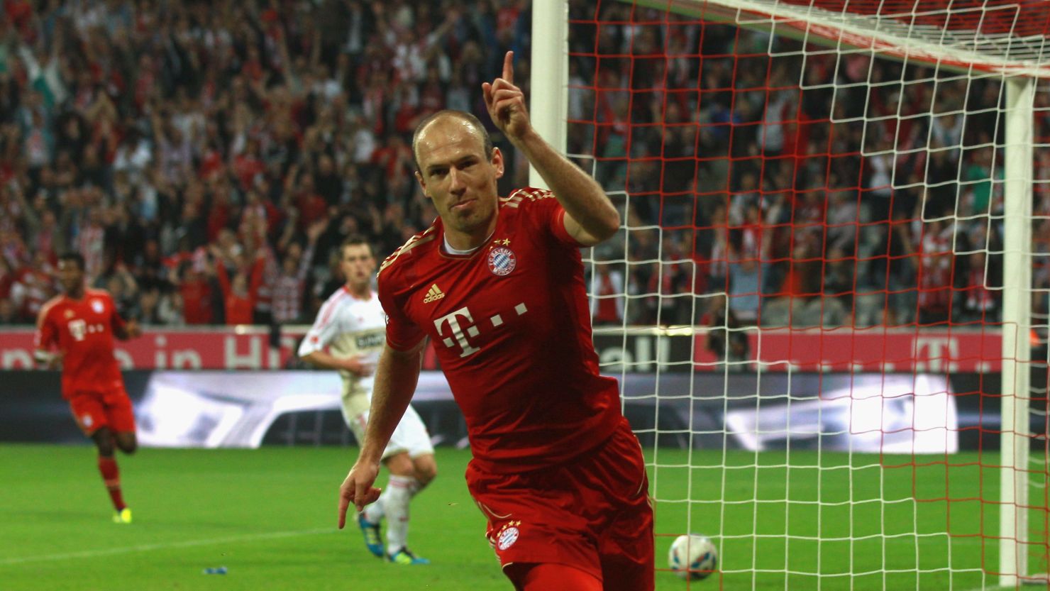 Arjen Robben celebrates scoring Bayern Munich's third goal against Bayer Leverkusen.