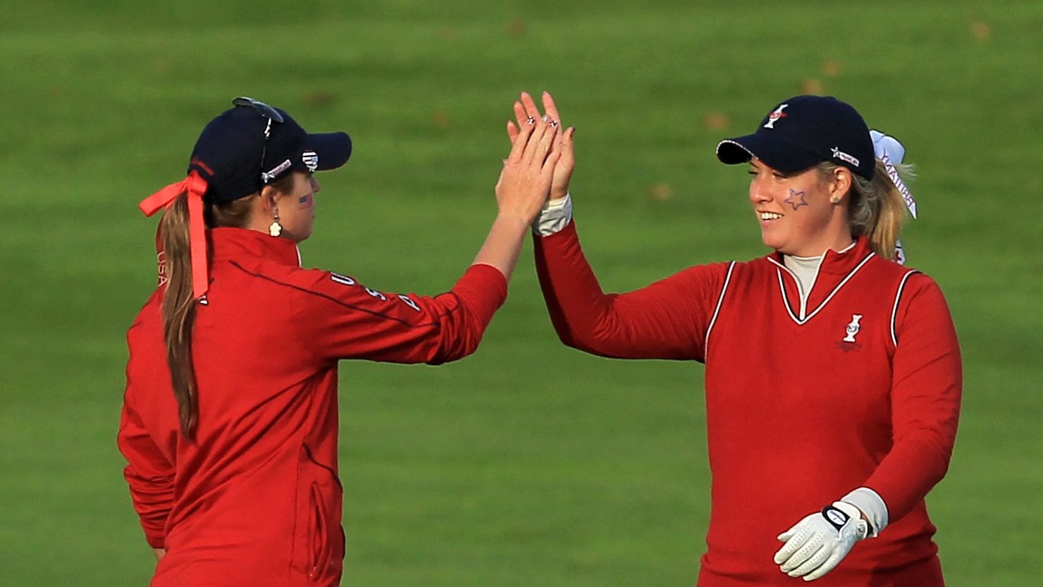 U.S. golfers Brittany Lincicome and Paula Creamer celebrate on the 16th hole during the afternoon fourballs.
