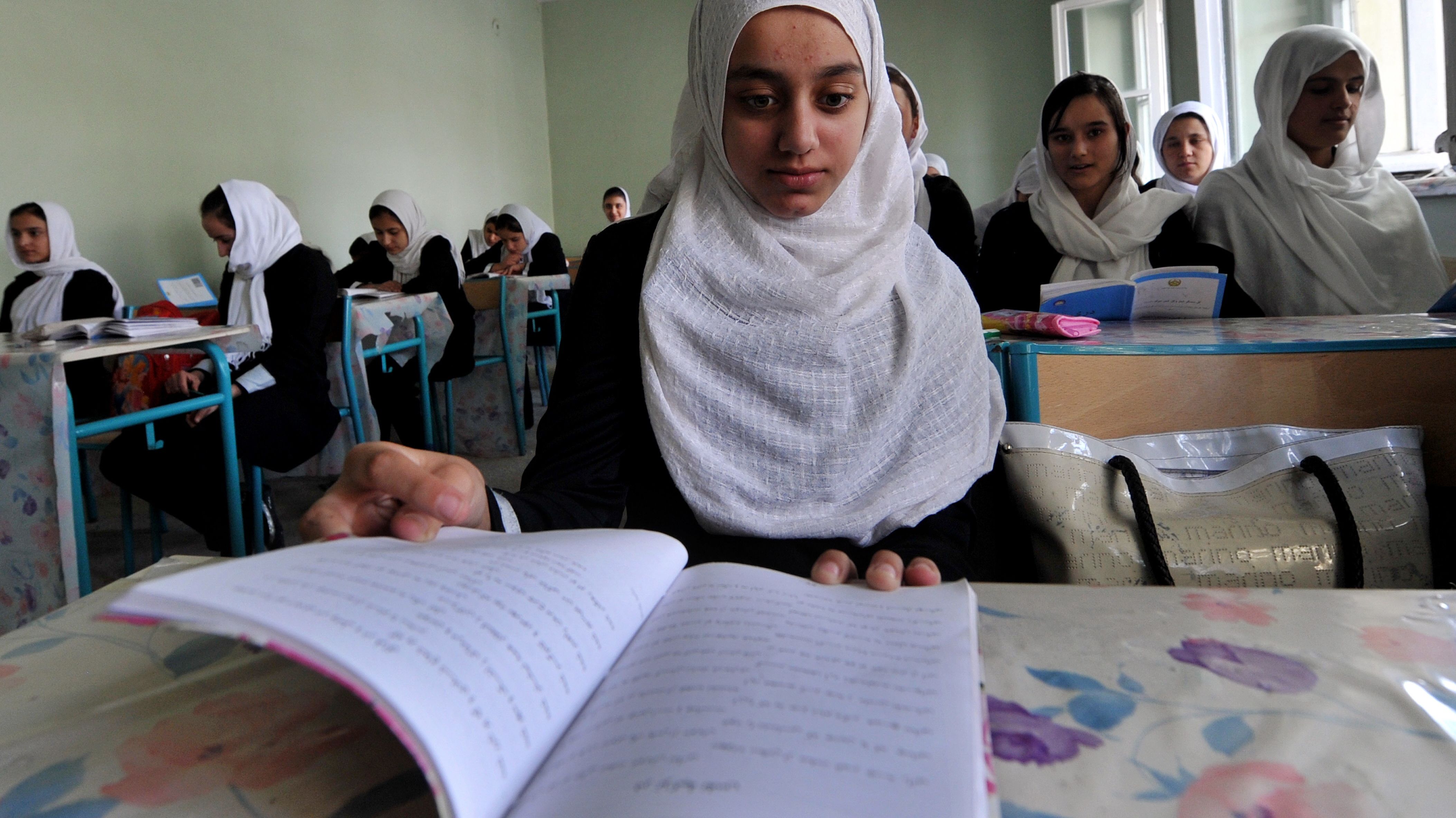 An Afghan high school student reads a textbook at the Lycee Malalai in Kabul on September 26. 