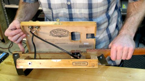 The inside of the cigar box guitar reveals its craftsmanship.