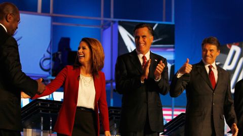 GOP candidates Herman Cain, from left, Michele Bachmann, Mitt Romney and Rick Perry chat before the September 12 debate.