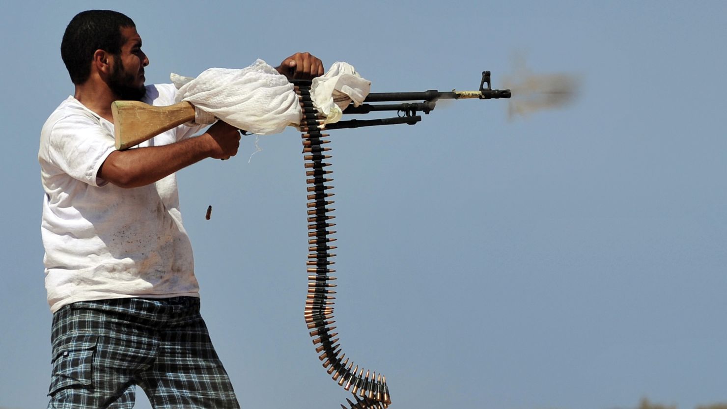 A National Transitional Council fighter practices firing his machine gun, 20 kilometers west of Sirte on September 26.