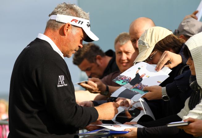 Reigning British Open champion Darren Clarke signs autographs before his practise round. 