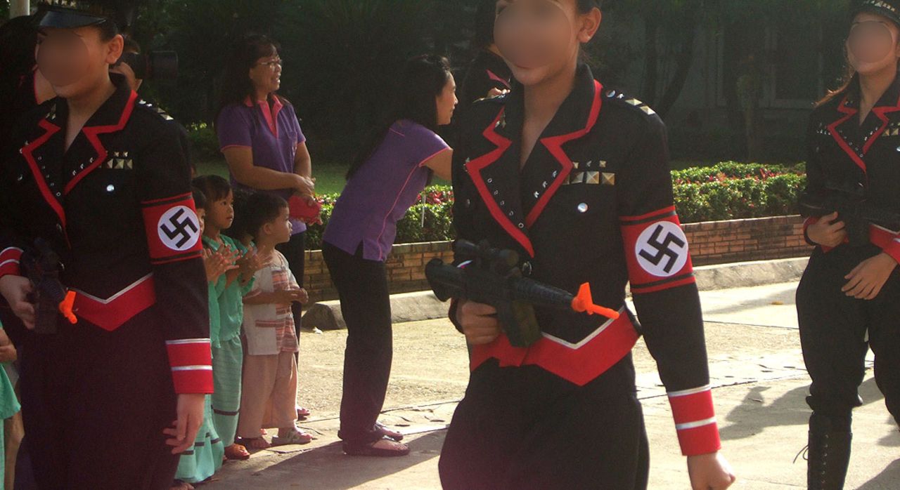 Students from the Sacred Heart School in Chiang Mai, Thailand took part in a parade wearing Nazi uniforms. Faces have been blurred to protect their identity. 