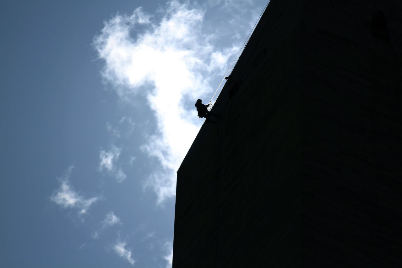 A worker descends the length of the monument after the earthquake. Officials said the heaviest damage seemed to be near the top of the structure.
