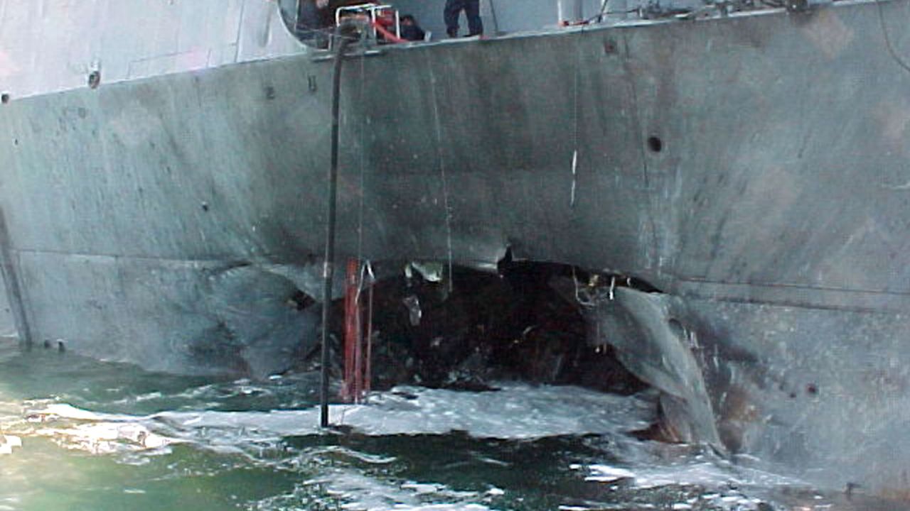 A gaping hole mars the port side of the USS Cole after a terrorist bomb killed 17 sailors in the Yemeni port of Aden in 2000.