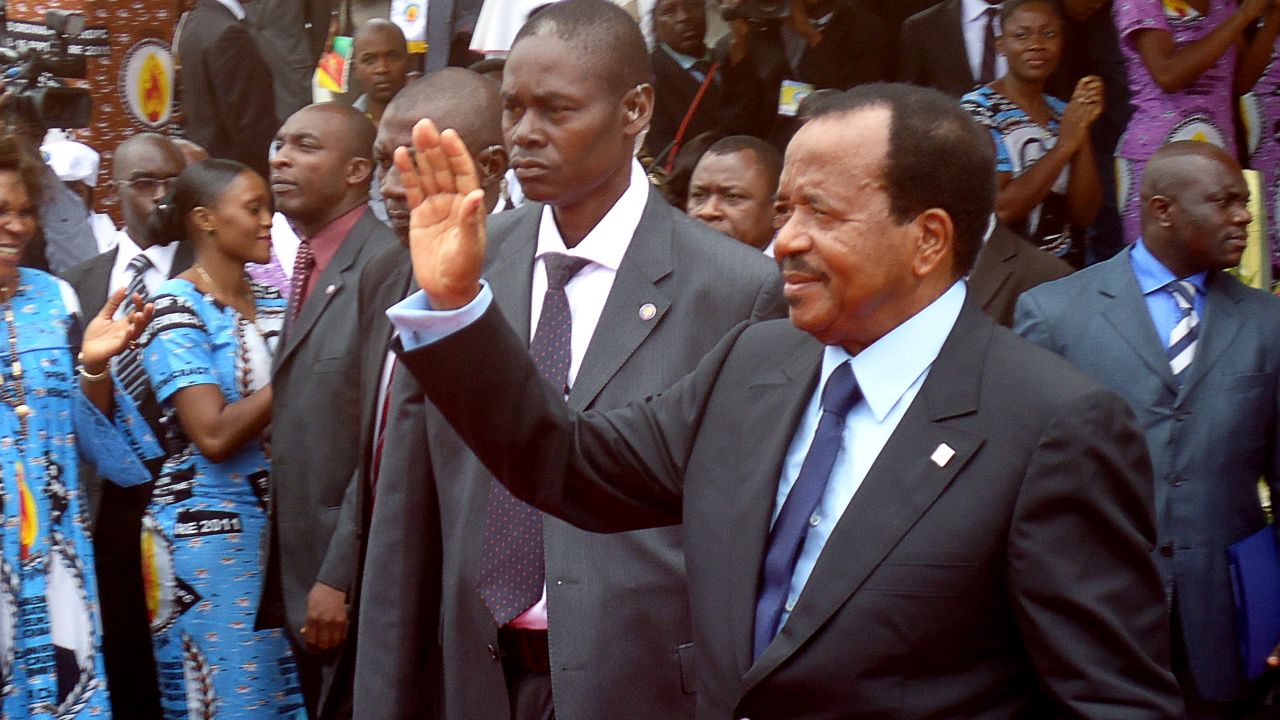 Cameroon's President Paul Biya waves to supporters during the opening of his party conference, in Yaounde, on September 15.