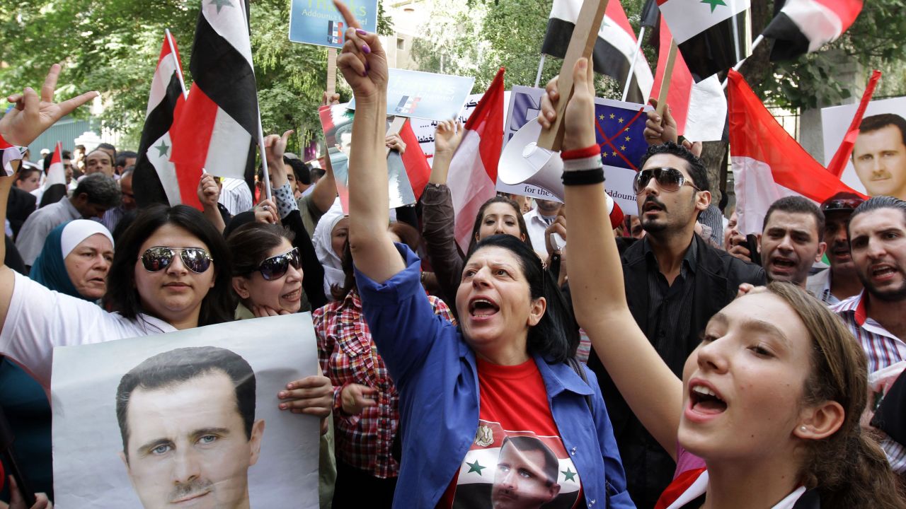 Syrian government supporters protest European Union sanctions in Damascus on Thursday.