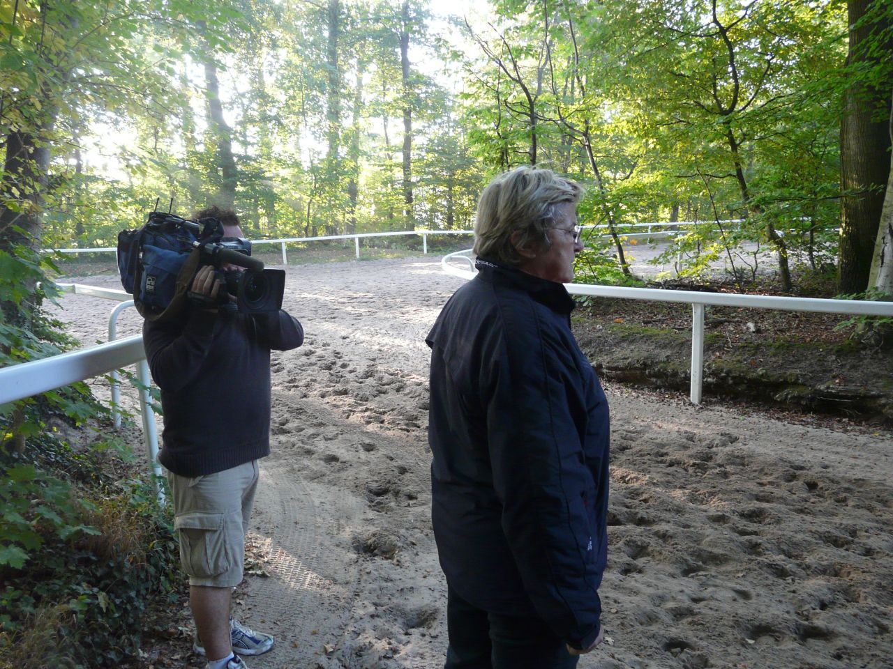 Head stands by the edge of the track, waiting to analyze her stable as they gallop past.