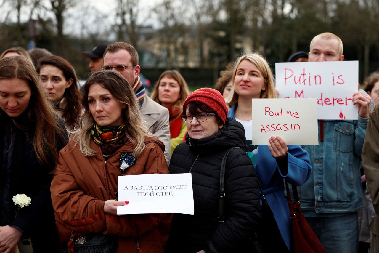 People hold placards as they gather near the Russian embassy following the death of Russian opposition leader Alexey Navalny, in Paris, France, on February 16.