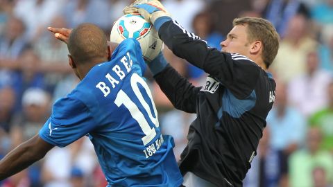 Bayern Munich keeper Manuel Neuer claims the ball from Hoffenheim striker Ryan Babel.