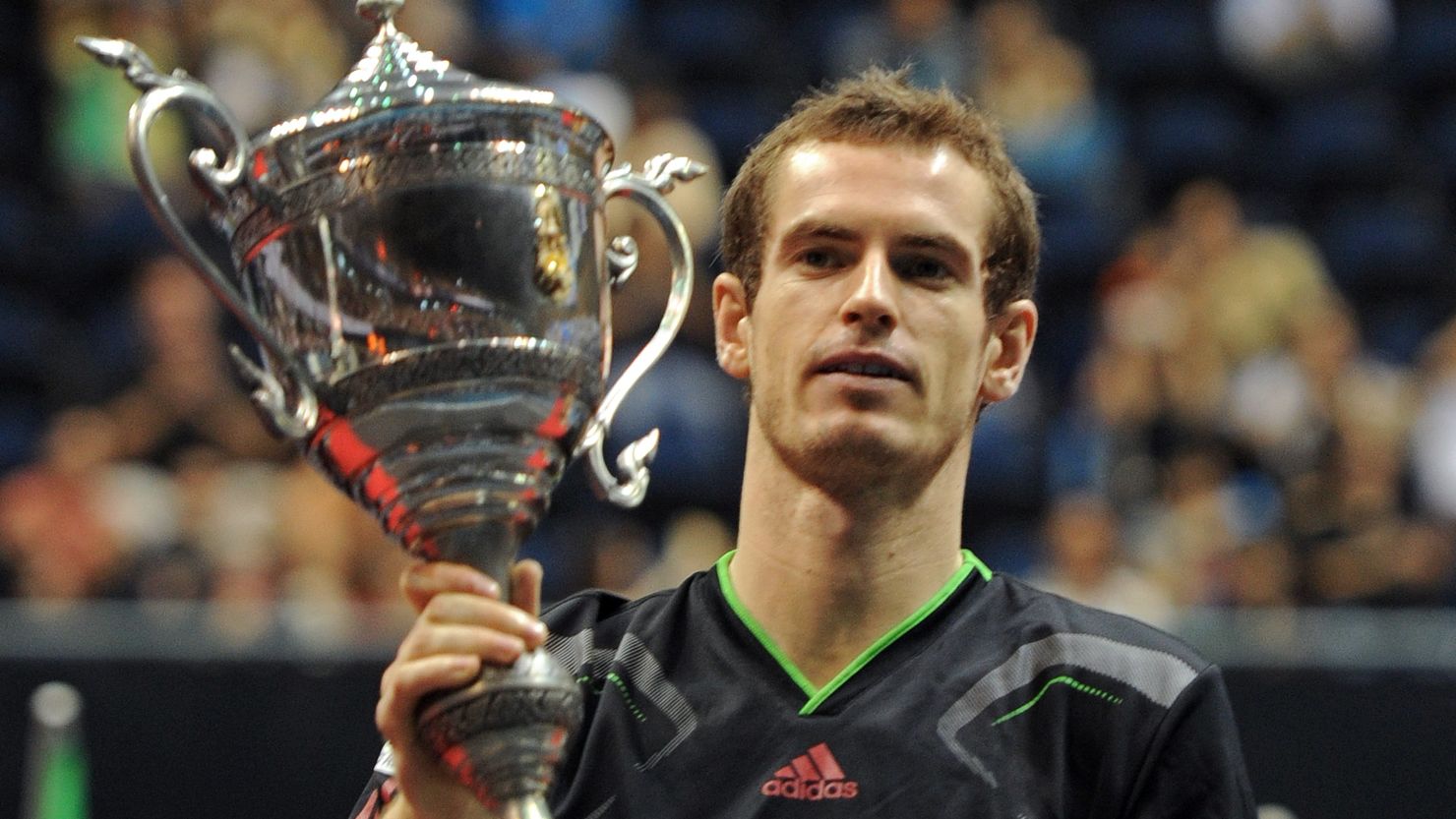 Andy Murray holds aloft the Thailand Open trophy after his easy win over Donald Young